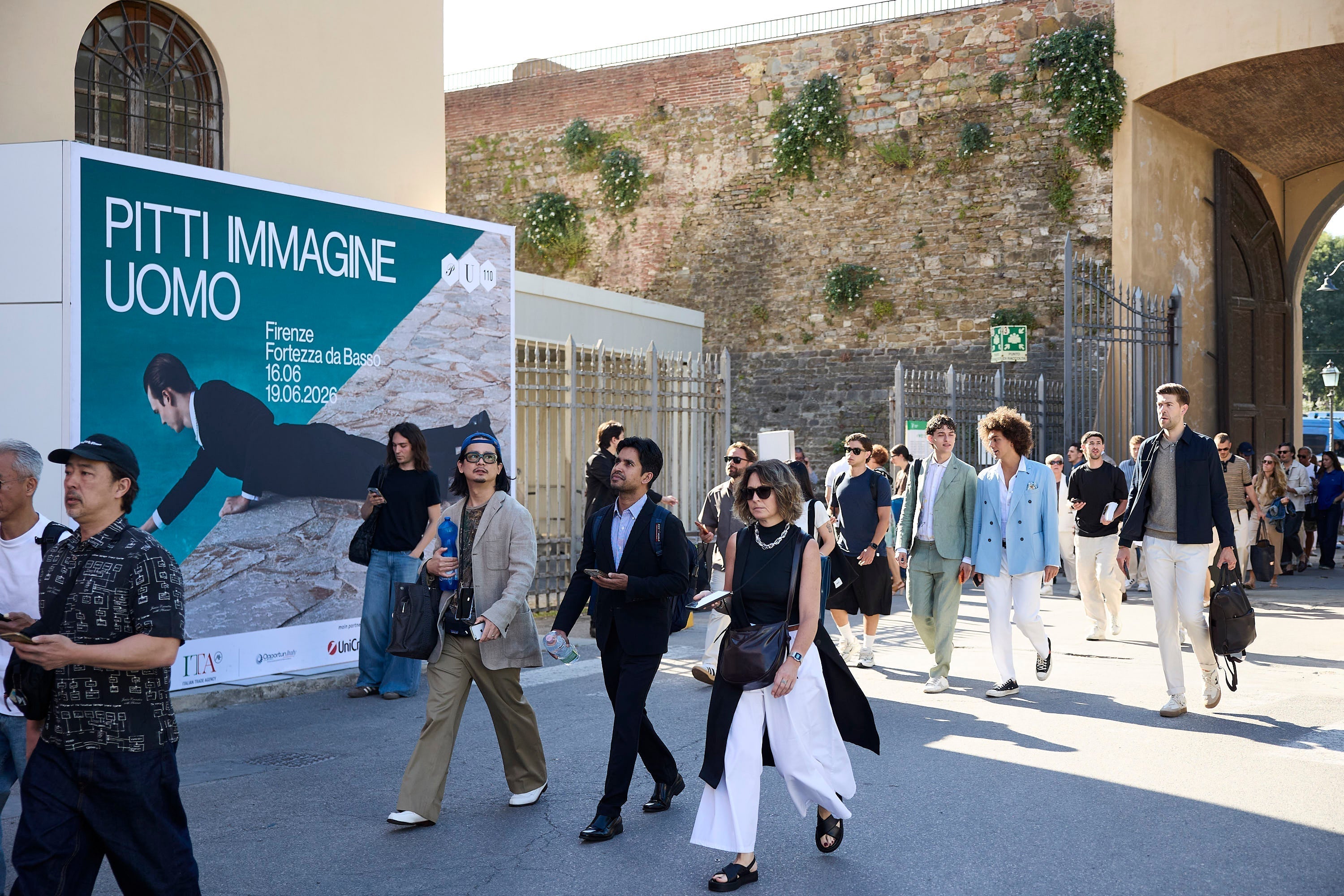 Official entrance sign and style attendees at Pitti Uomo 110 in Florence